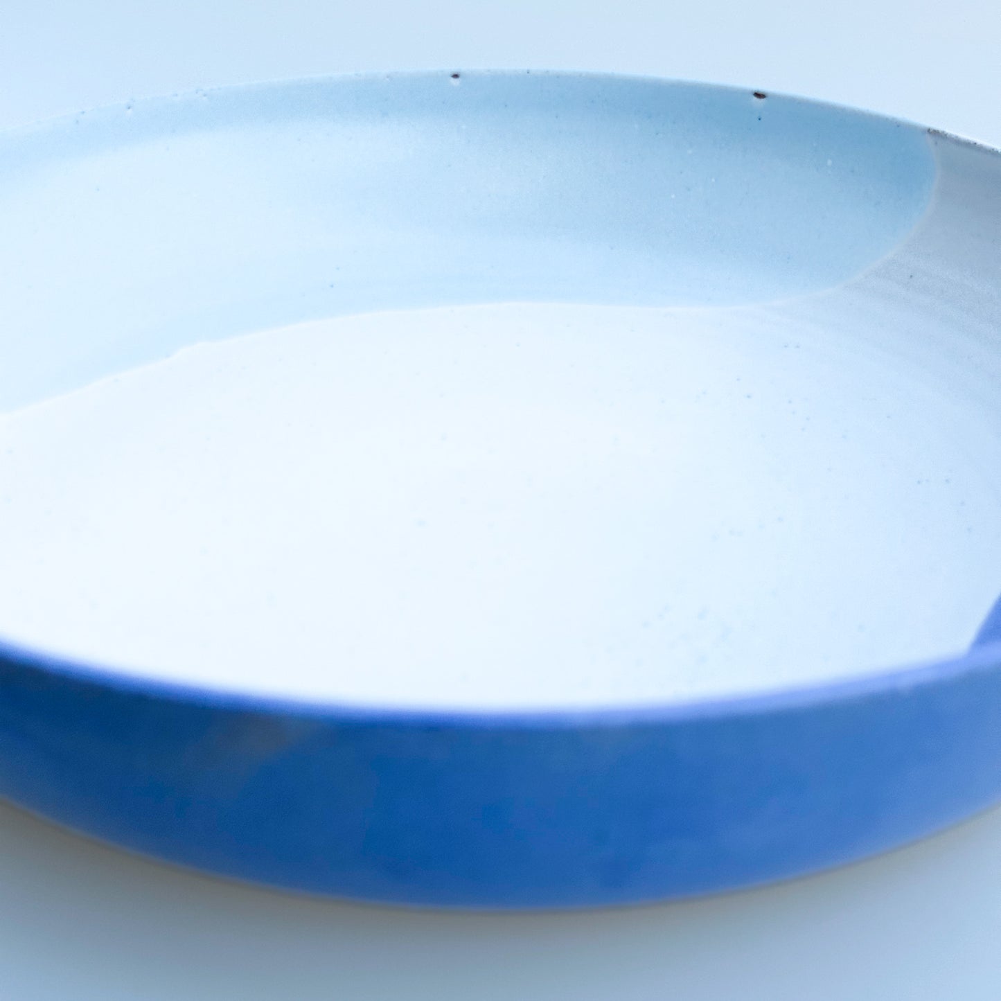 Close-up of a blue ceramic dish on a white background