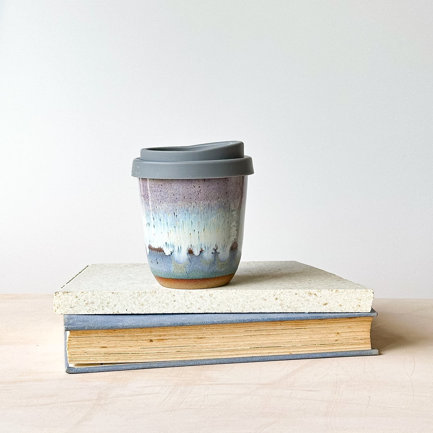 take-away keep cup on a tile with a light background.