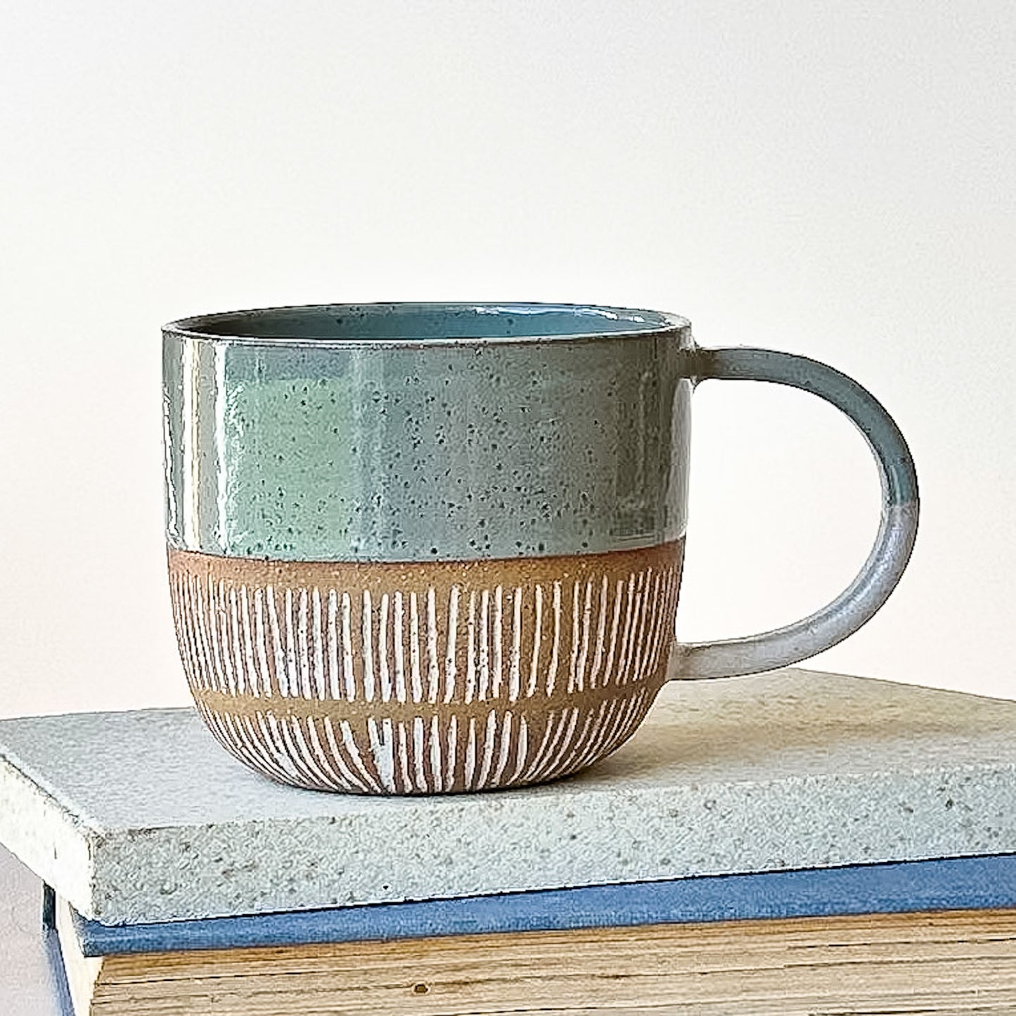 Ceramic mug with a textured design on a light surface