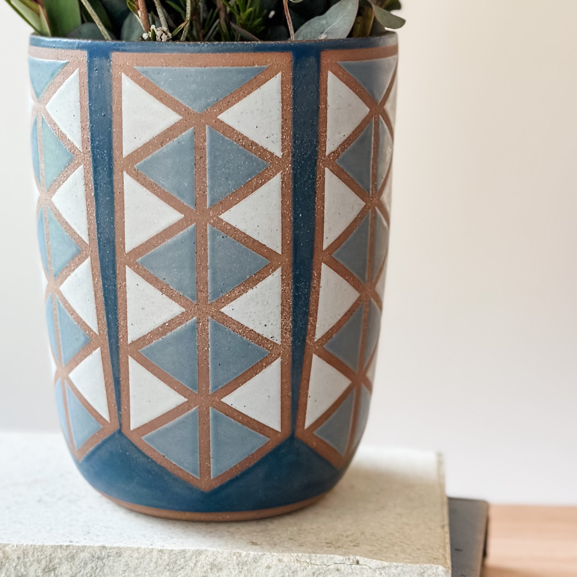 Ceramic vase with geometric pattern on a neutral background