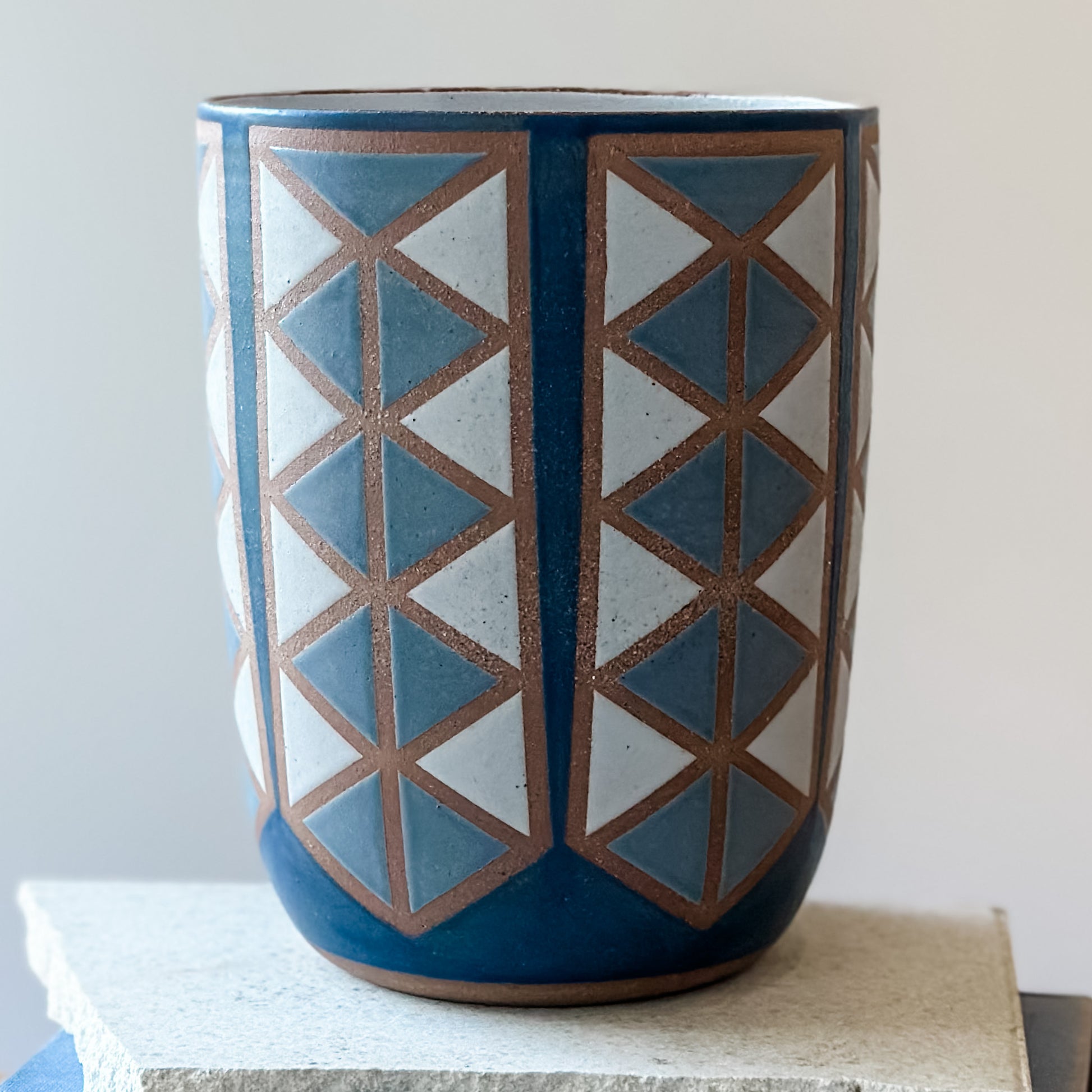 Ceramic vase with geometric pattern on a white background