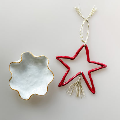 Decorative star-shaped ornament and round dish on a light gray background