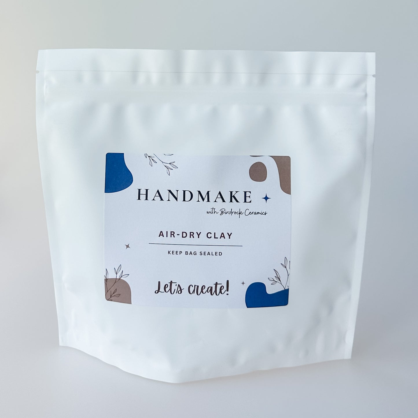 White air-dry clay packaging with 'Handmake' branding on a light gray background