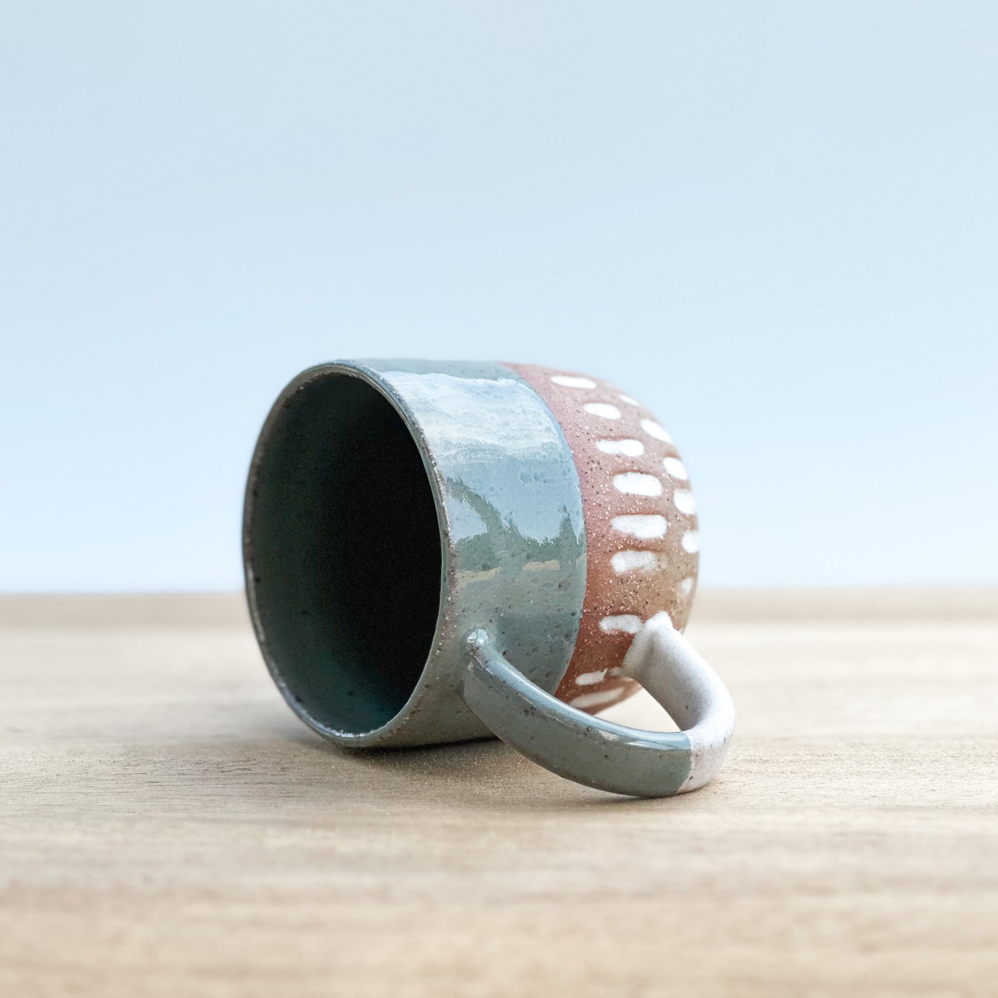 Ceramic espresso mug with a unique design on a wooden surface