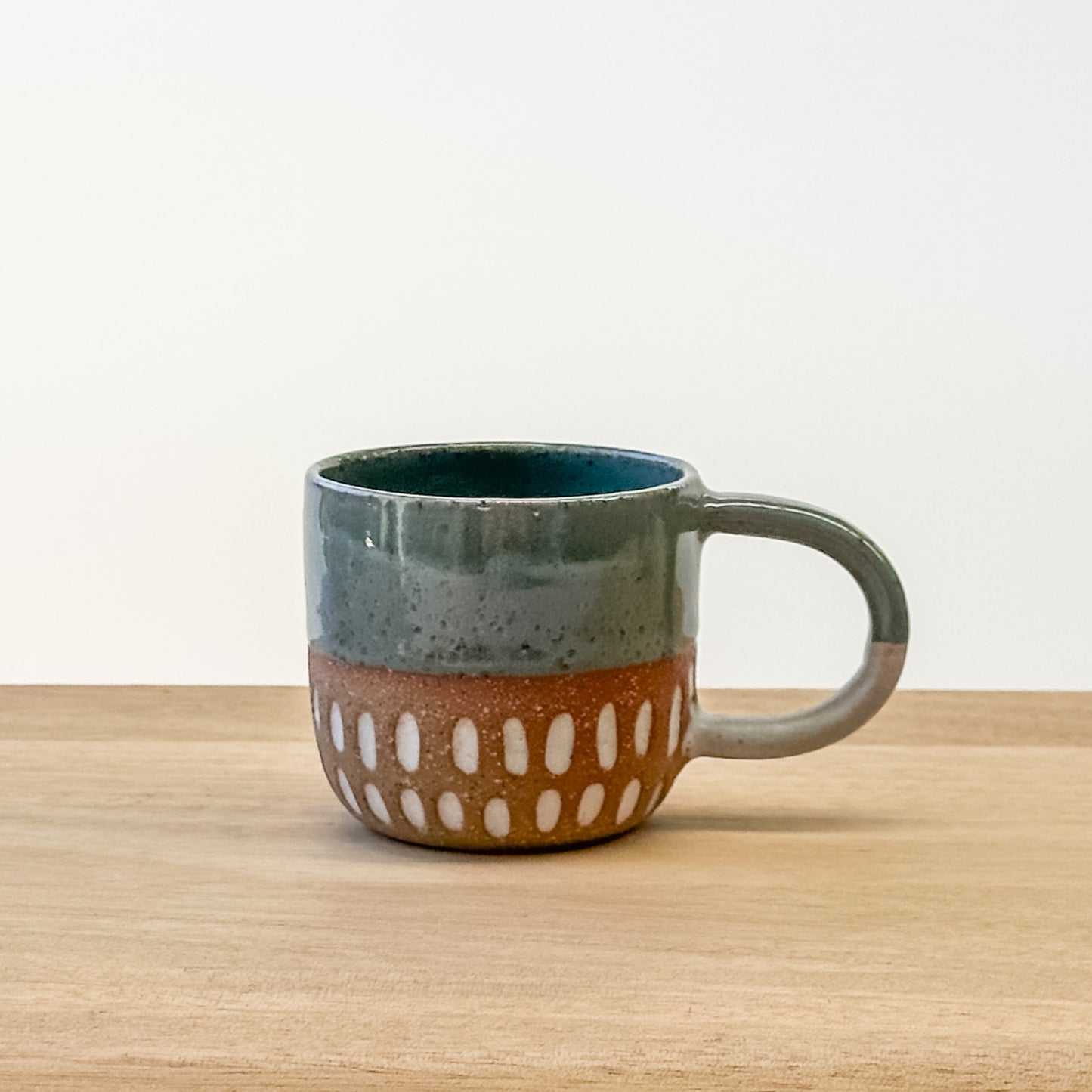 Ceramic espresso mug with a unique design on a wooden surface
