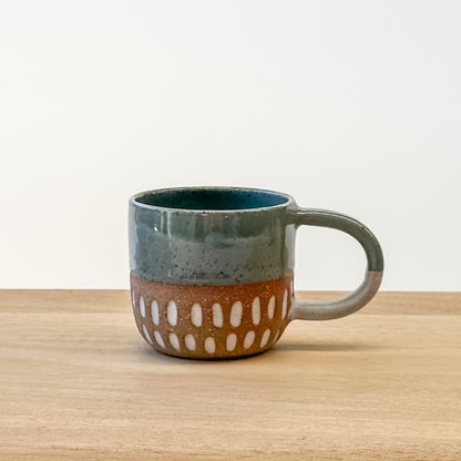 Ceramic espresso mug with a unique design on a wooden surface