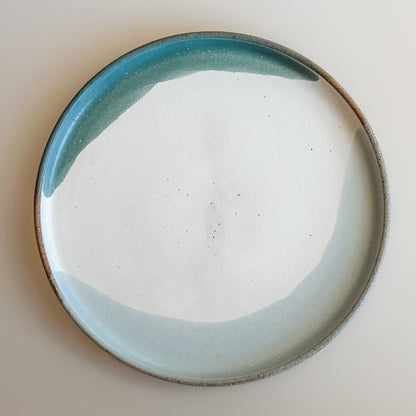 An aerial view of the small Tidal Handmade Ceramic Plate in a white, green and blue-grey glaze. The plate sits on a white background.