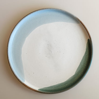 An aerial view of the small Tidal Handmade Ceramic Plate in a white, green and blue-grey glaze. The plate sits on a white background.